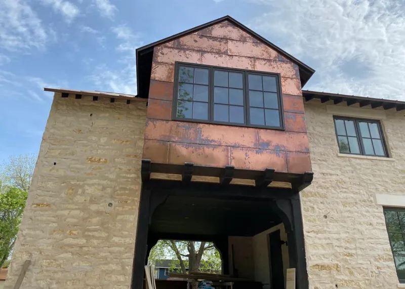 Copper metal panel facade on a stone building for Skylight Installation in Silver Lakes